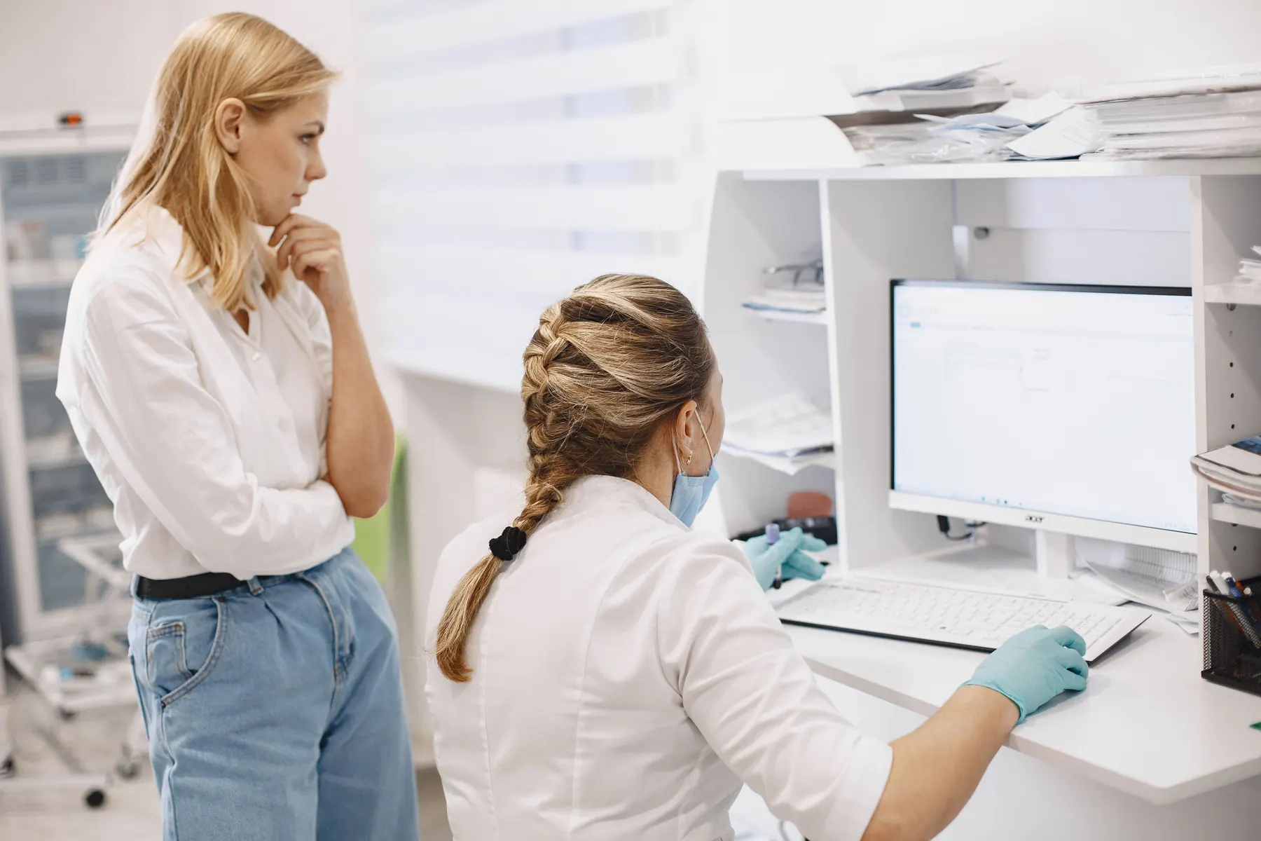 Healthcare professionals reviewing information at a clinical computer workstation