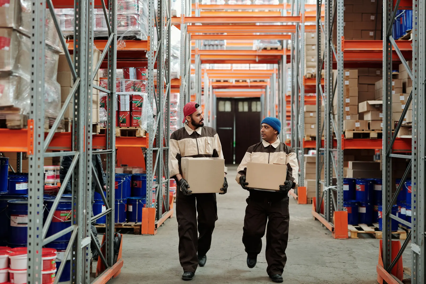 Warehouse workers moving inventory through a distribution aisle